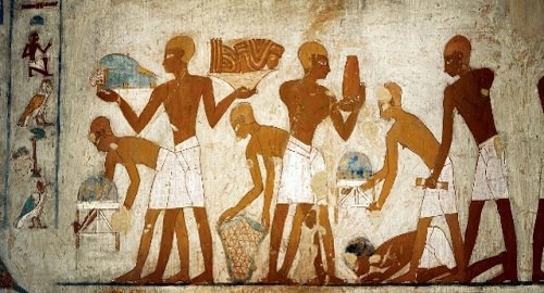 Imagen de artesanos y granjeros pagando sus tributos al visir Rekhmire (dinastía XVIII) en esta pintura de su tumba en Gurna.
